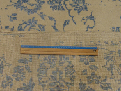Blue and ivory transitional rug in room setting