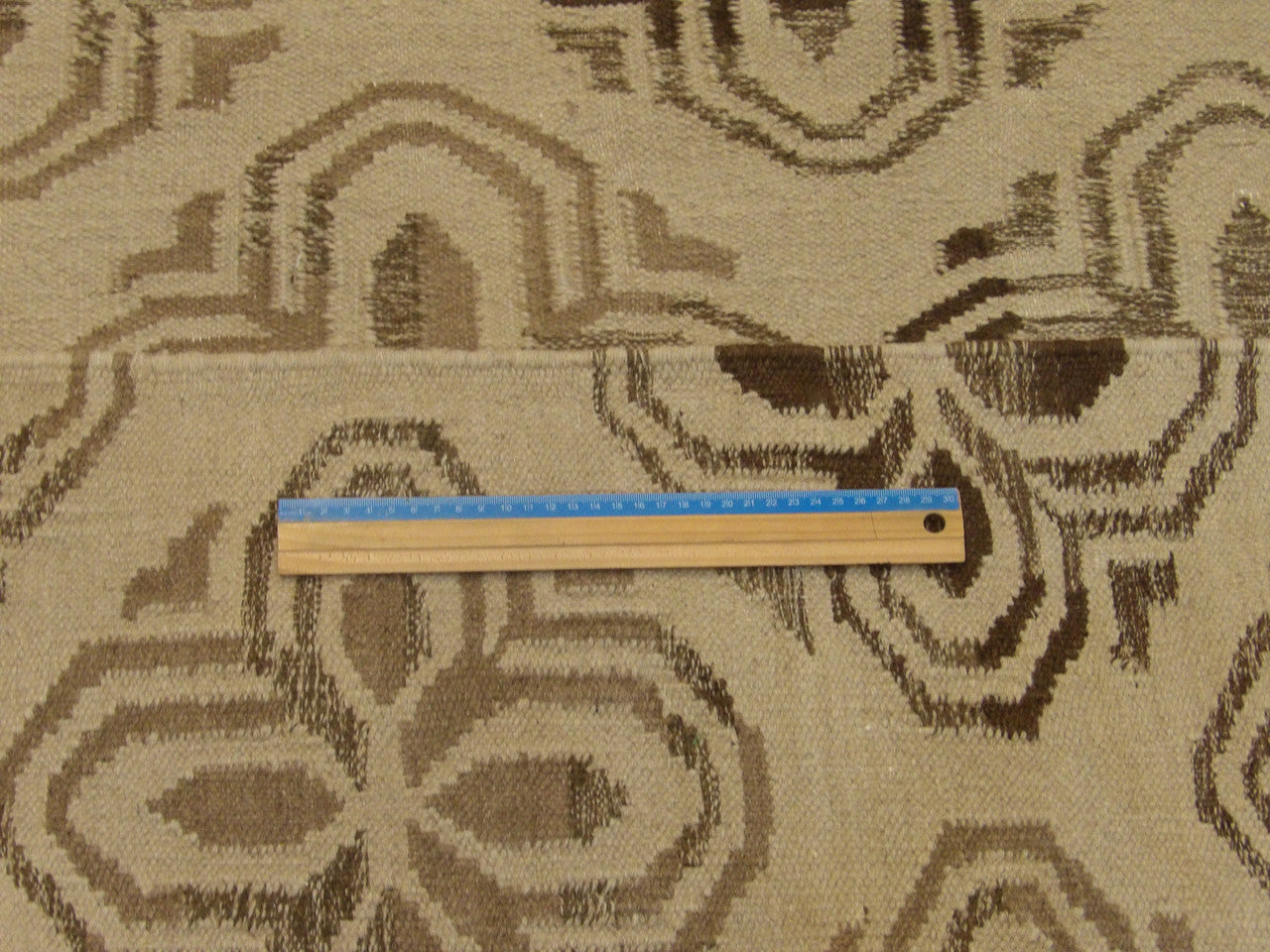 Brown and beige coastal rug in room setting
