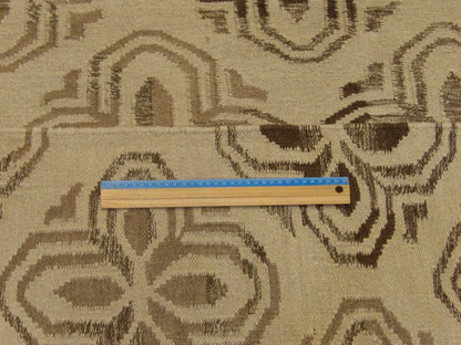Brown and beige coastal rug in room setting