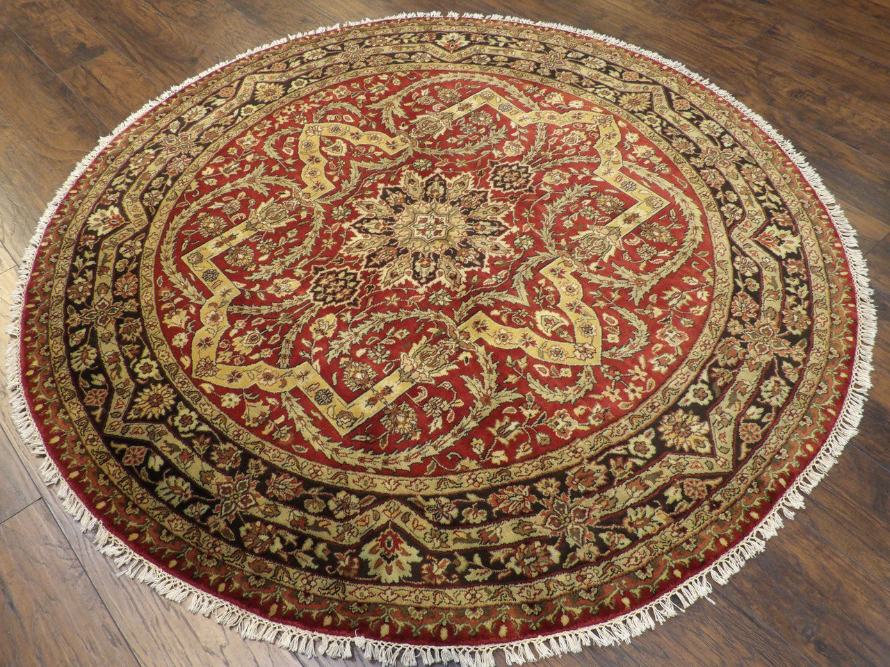 Black and red round Persian rug in a living room setting