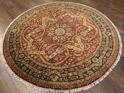 Black and red round Persian rug in a living room setting