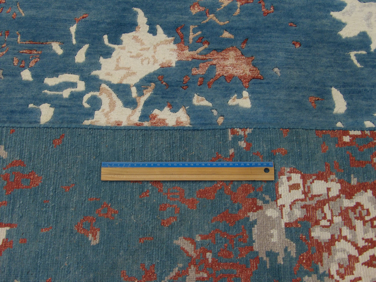 Rust and teal abstract rug in room setting