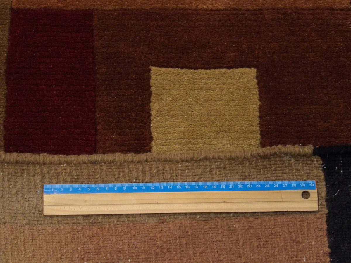 Full room view of modern geometrical hand-knotted rug