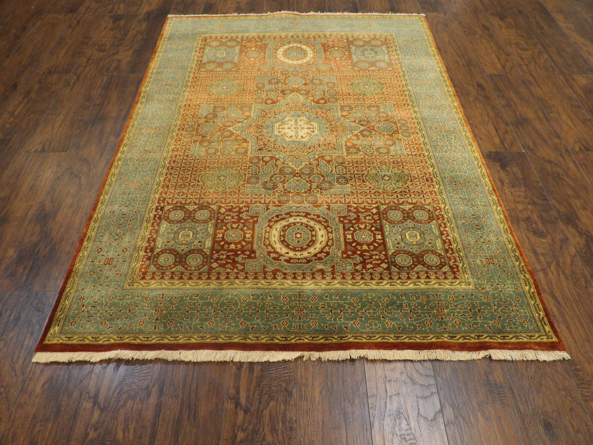 Close-up of wool pile, green and rust rug