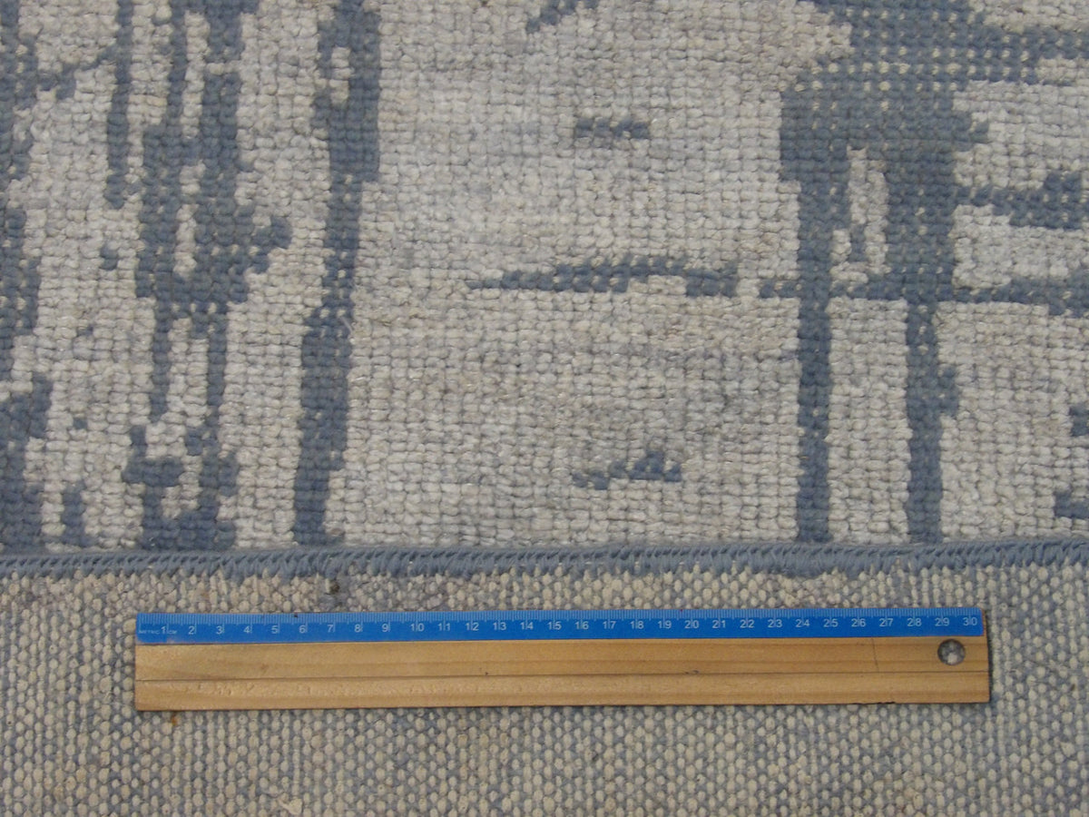 Full room view of transitional abstract hand-knotted rug