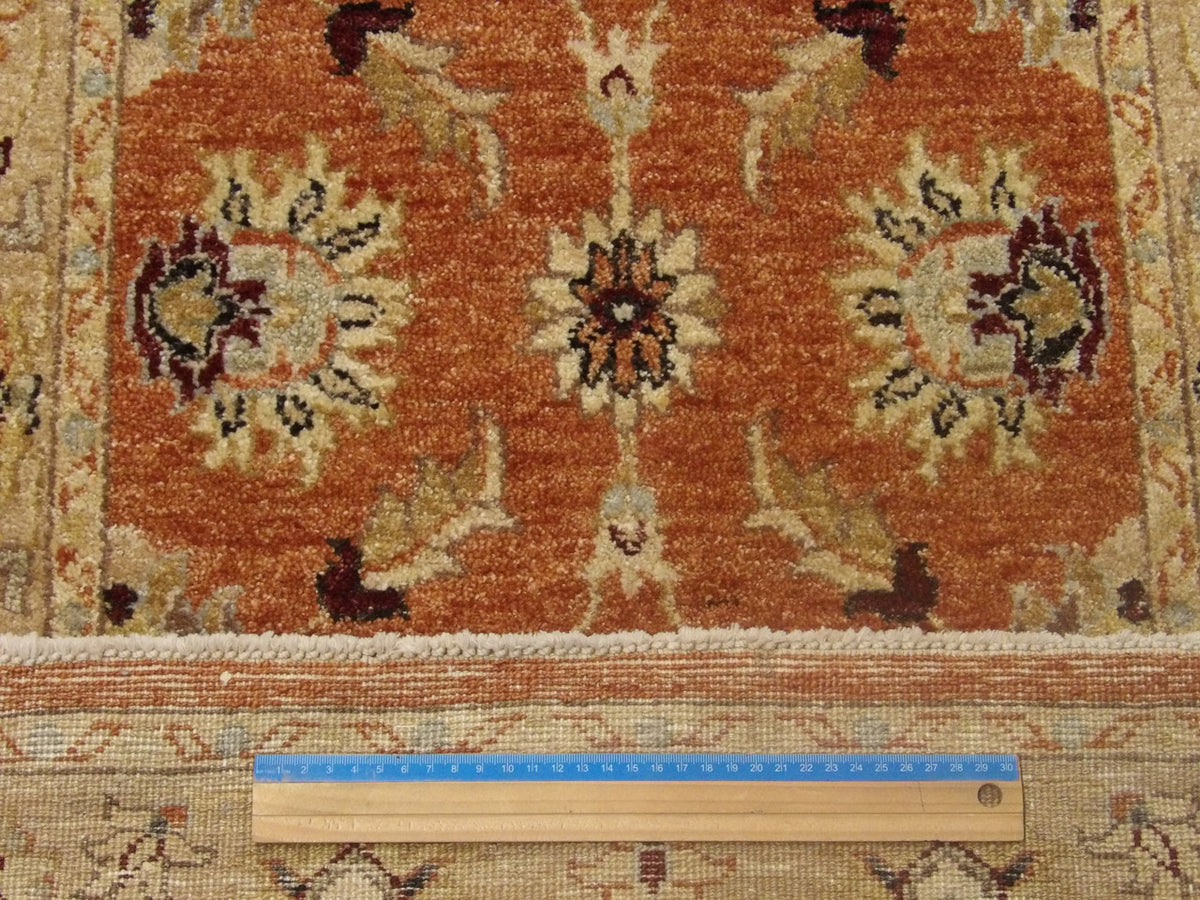 Gold and red Oushak runner in hallway setting