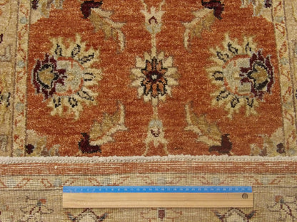 Gold and red Oushak runner in hallway setting