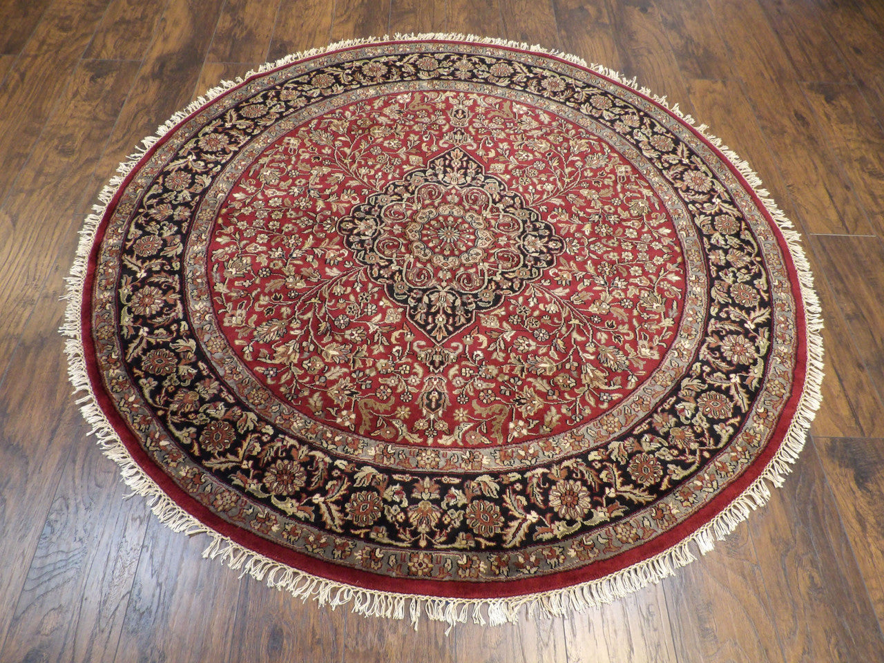 Close-up of wool pile, black and red round rug