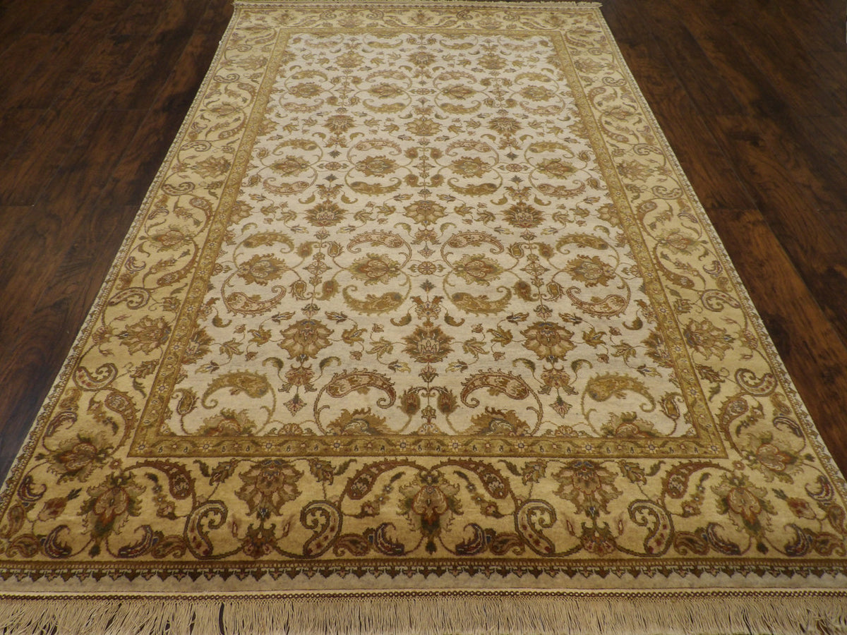 Close-up of wool pile, gold and ivory rug