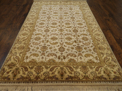 Close-up of wool pile, gold and ivory rug