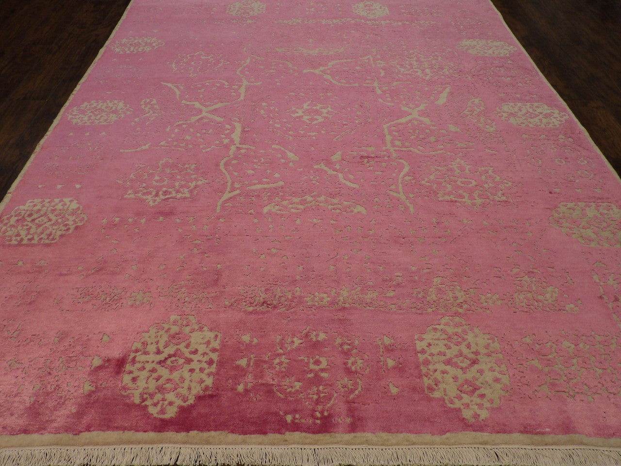 Close-up of carved wool-silk pile, beige and pink rug