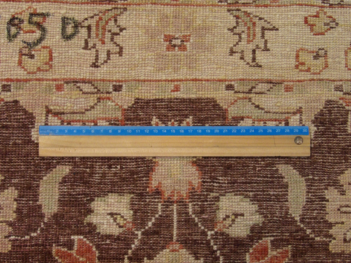 Brown and beige Oushak rug in room setting