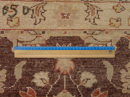 Brown and beige Oushak rug in room setting