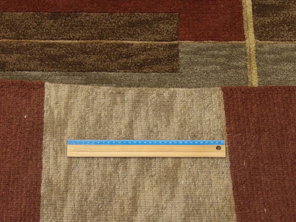 Wool texture close-up, gold and red geometric rug
