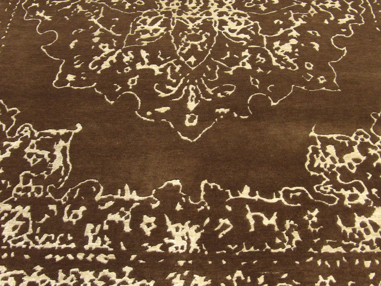 Broken Heriz rug edge and pile detail, brown and gold