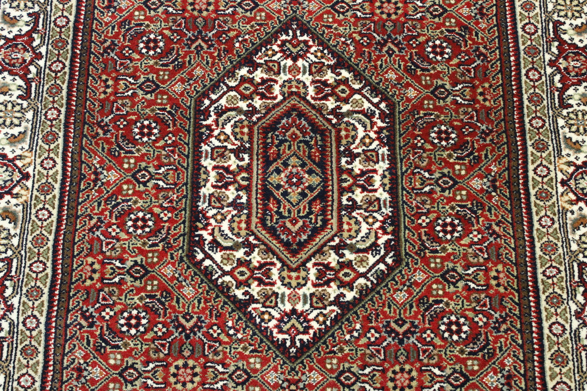 Beige & Red Traditional Indo Bidjar rug in room setting