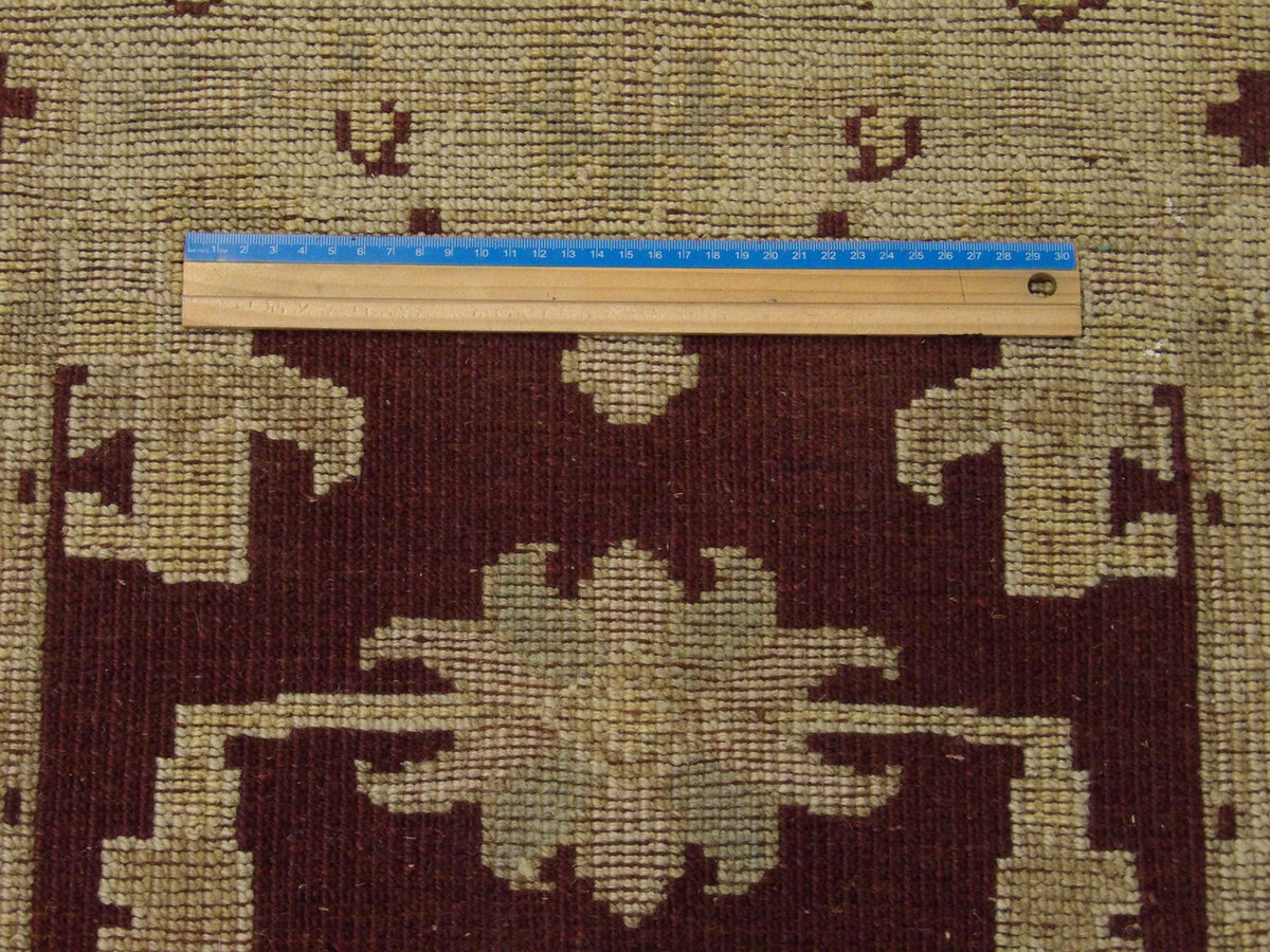 Brown and beige Oushak rug in room setting