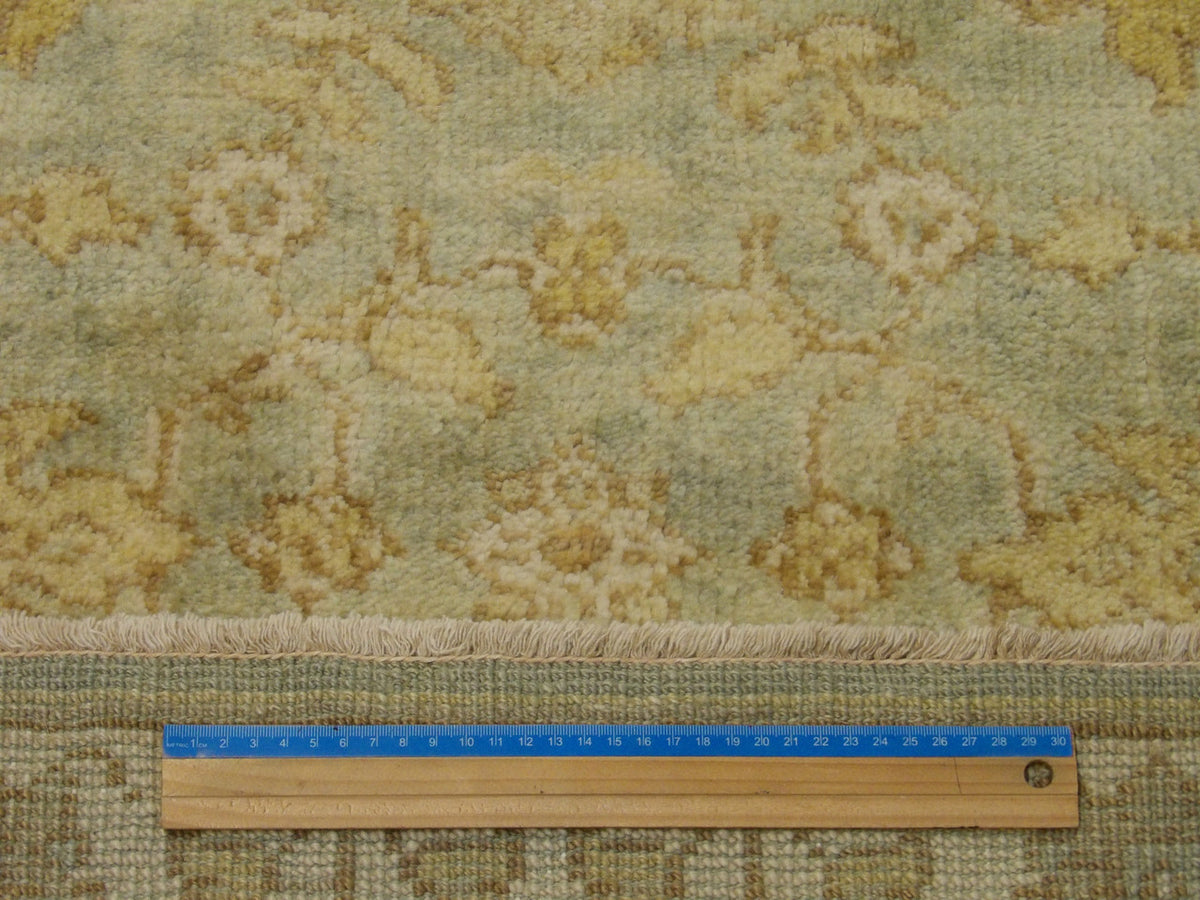 Green & Beige Wash Oushak rug in room setting