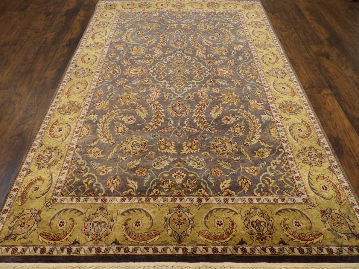 Close-up of wool pile, gold and purple rug