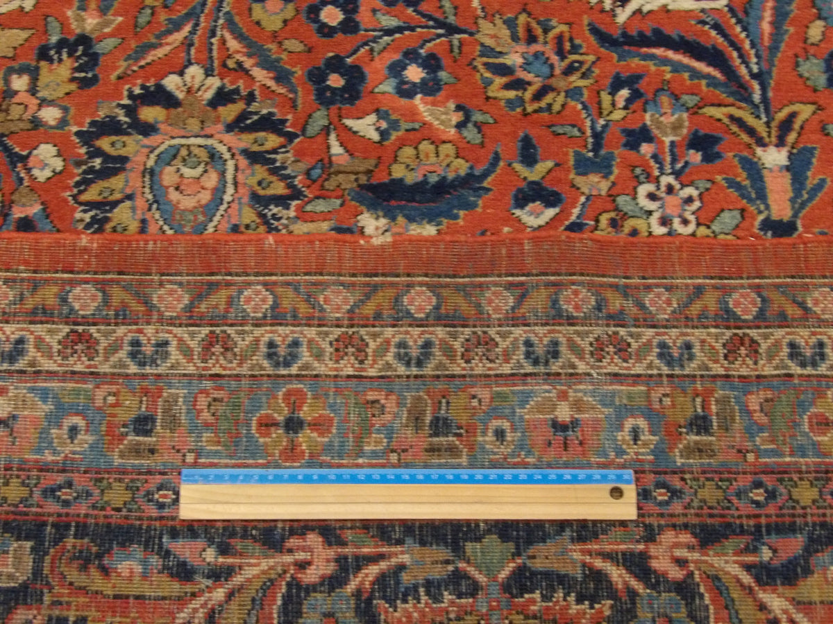 Blue and red antique Tabriz rug in room setting