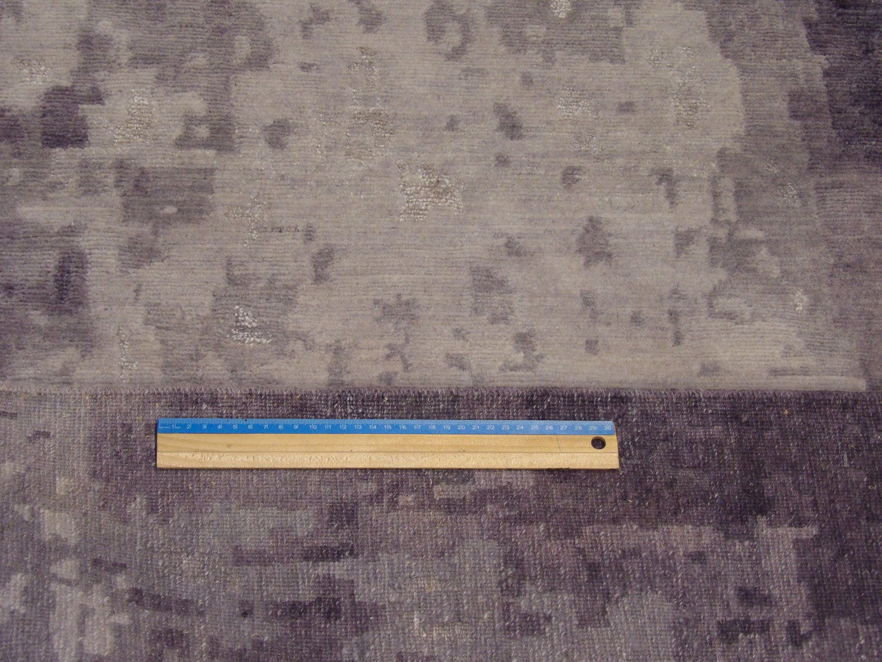 Gray and purple abstract rug in room setting