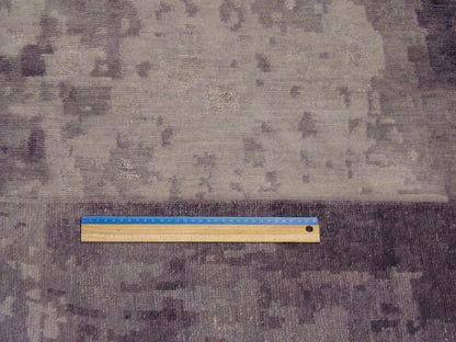 Gray and purple abstract rug in room setting