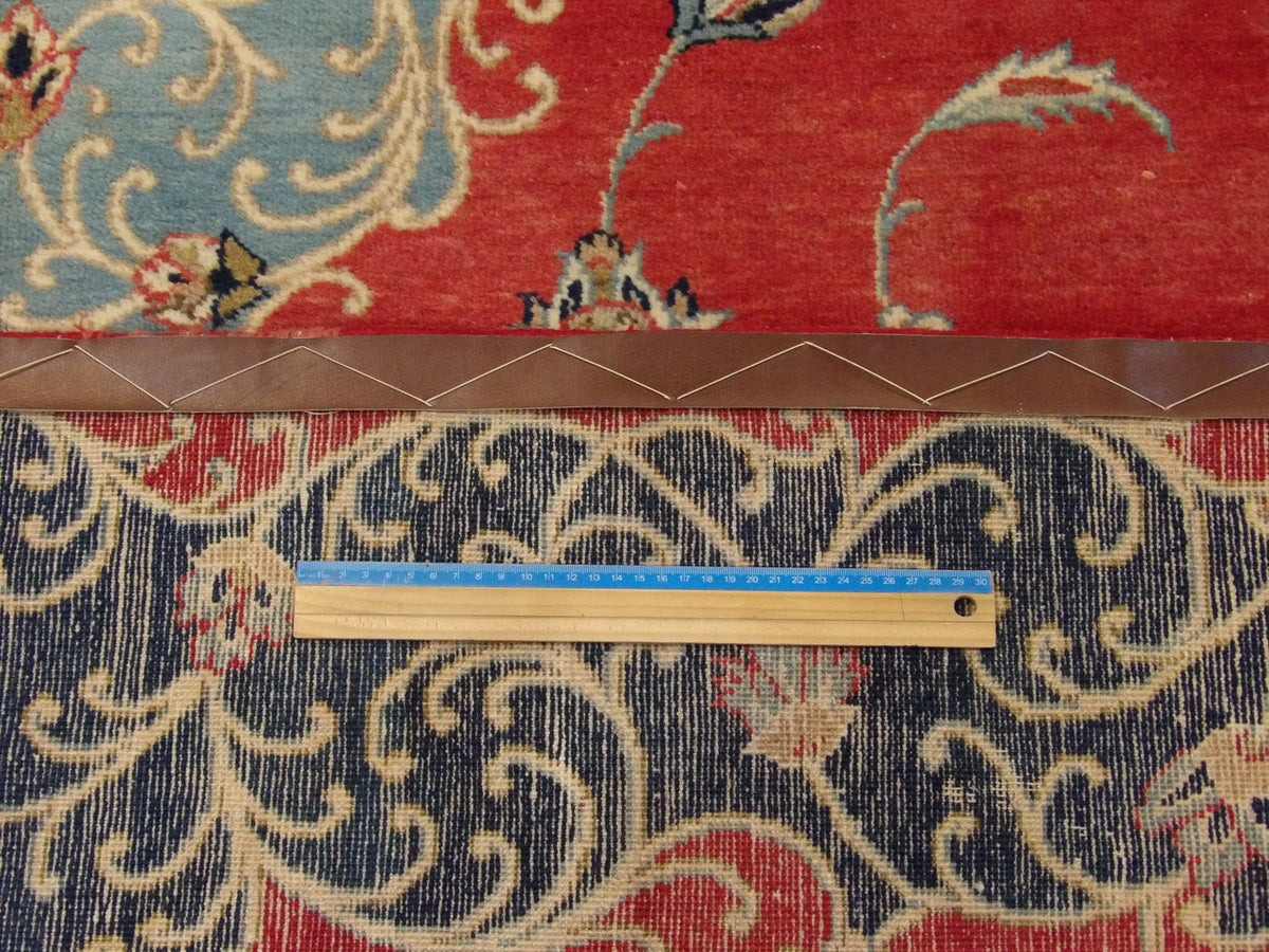 Blue & Red Fine Persian Tabriz rug in room setting