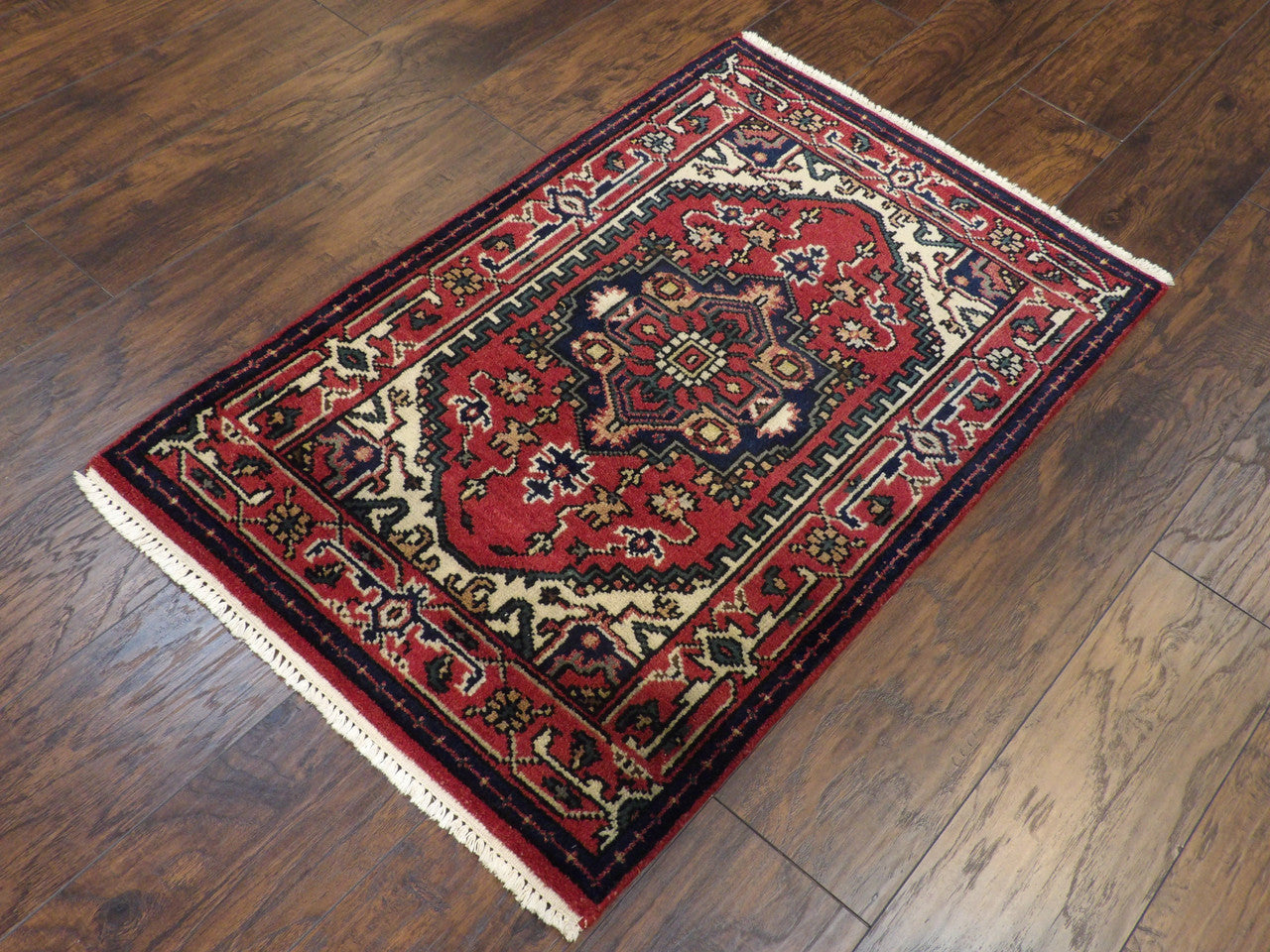 Tribal Heriz geometric pattern detail, red hand-knotted rug