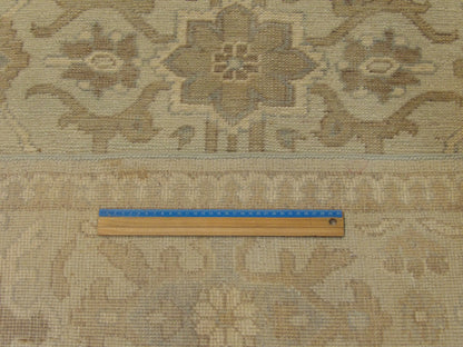 Green and beige Khotan rug in room setting