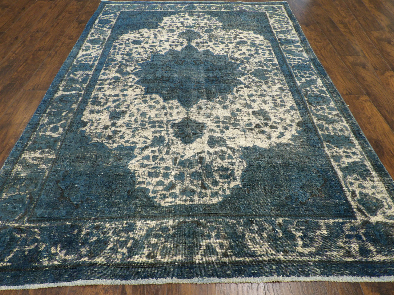 Close-up of shaved wool pile, teal rug