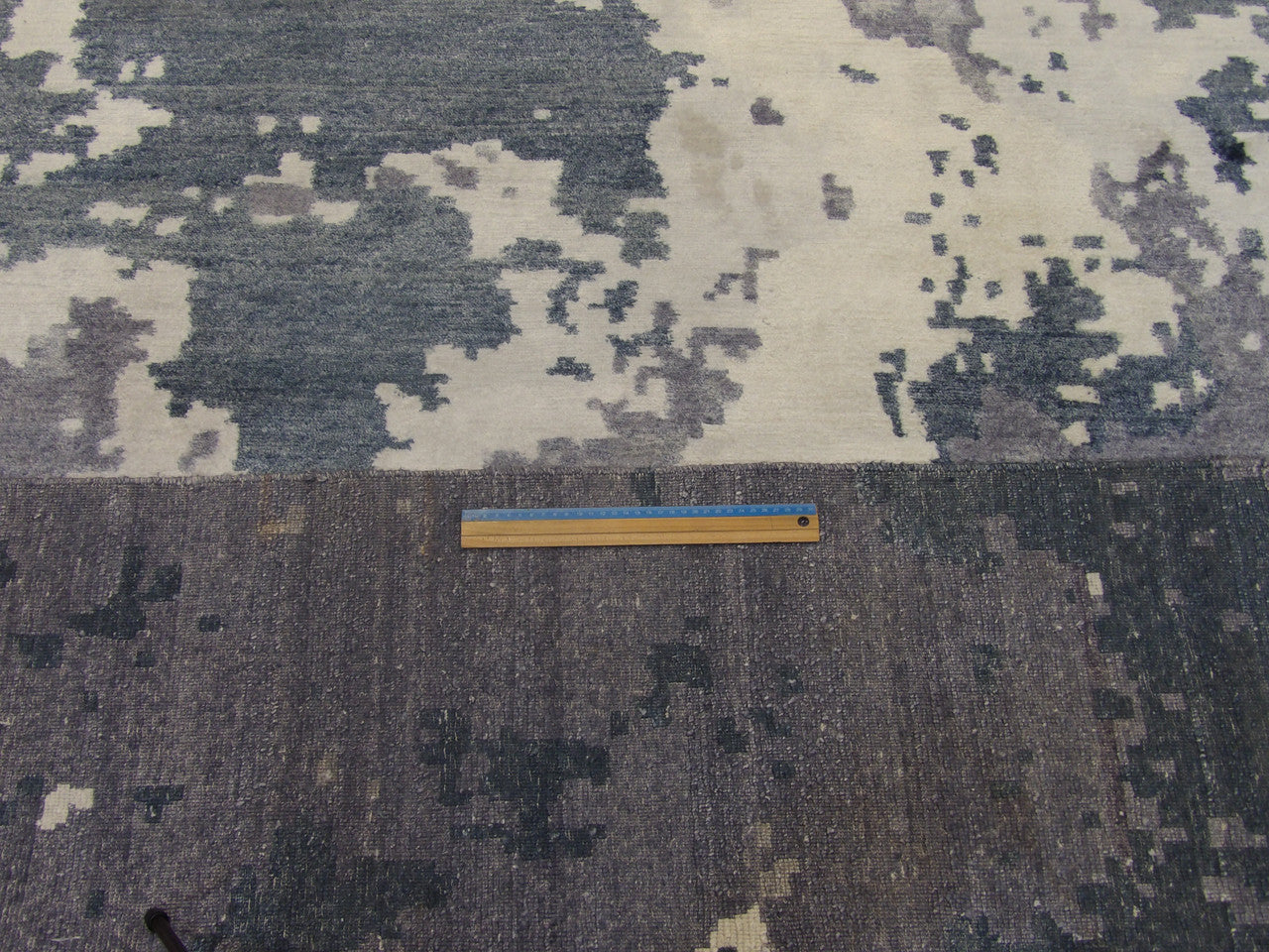 Full room view of modern abstract ocean hand-knotted rug