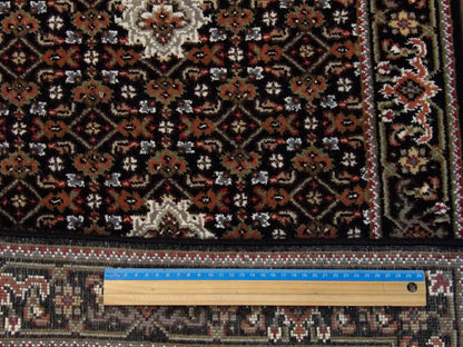 Black Persian Mahi Tabriz rug in room setting