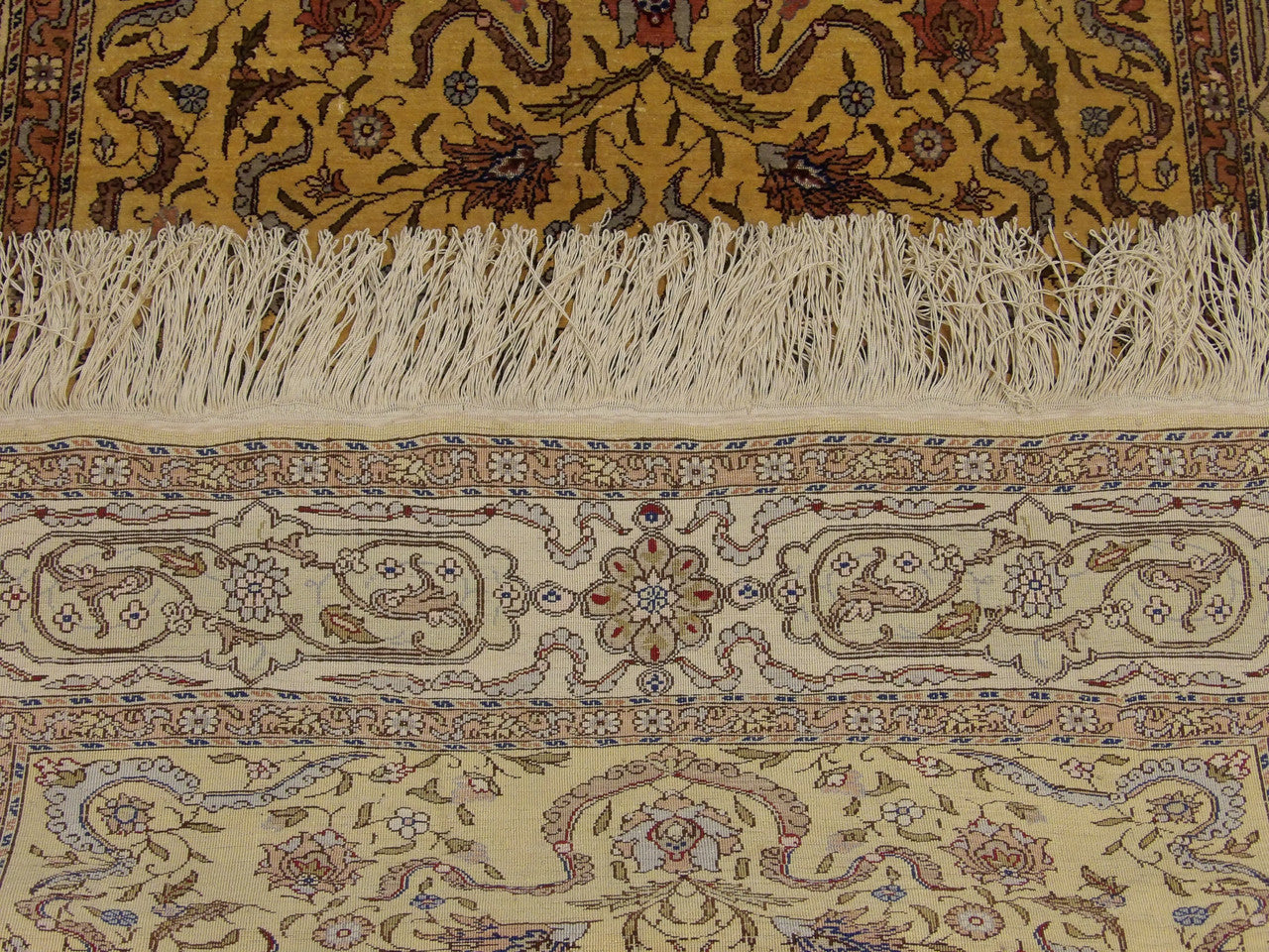 Gold Tabriz rug in room setting