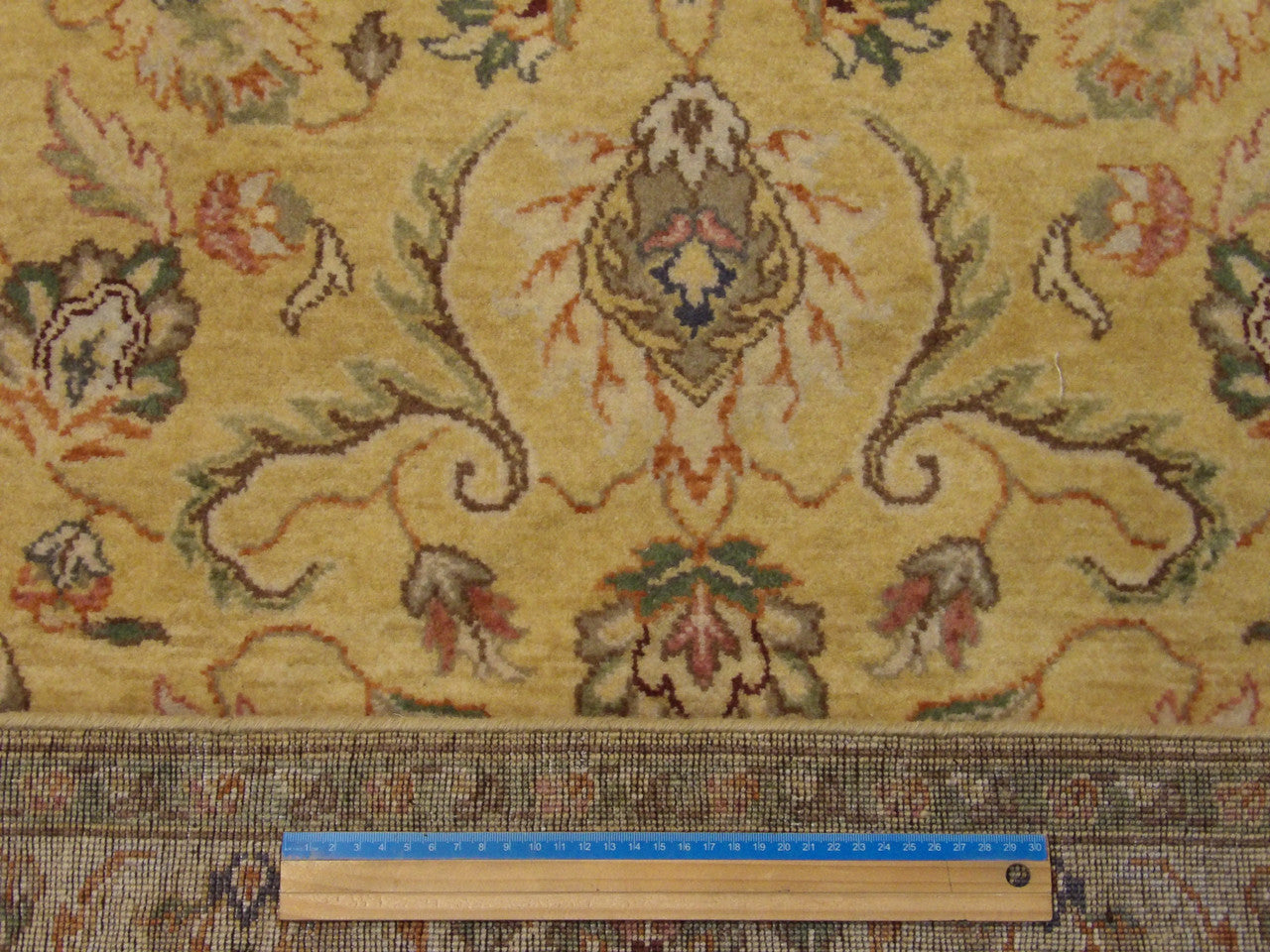 Gold and ivory Kashan rug in room setting