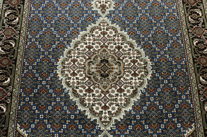 Traditional Tabriz rug corner detail