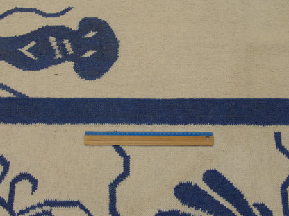 Blue & White Coastal Flat Weave Indoor/Outdoor rug in room setting