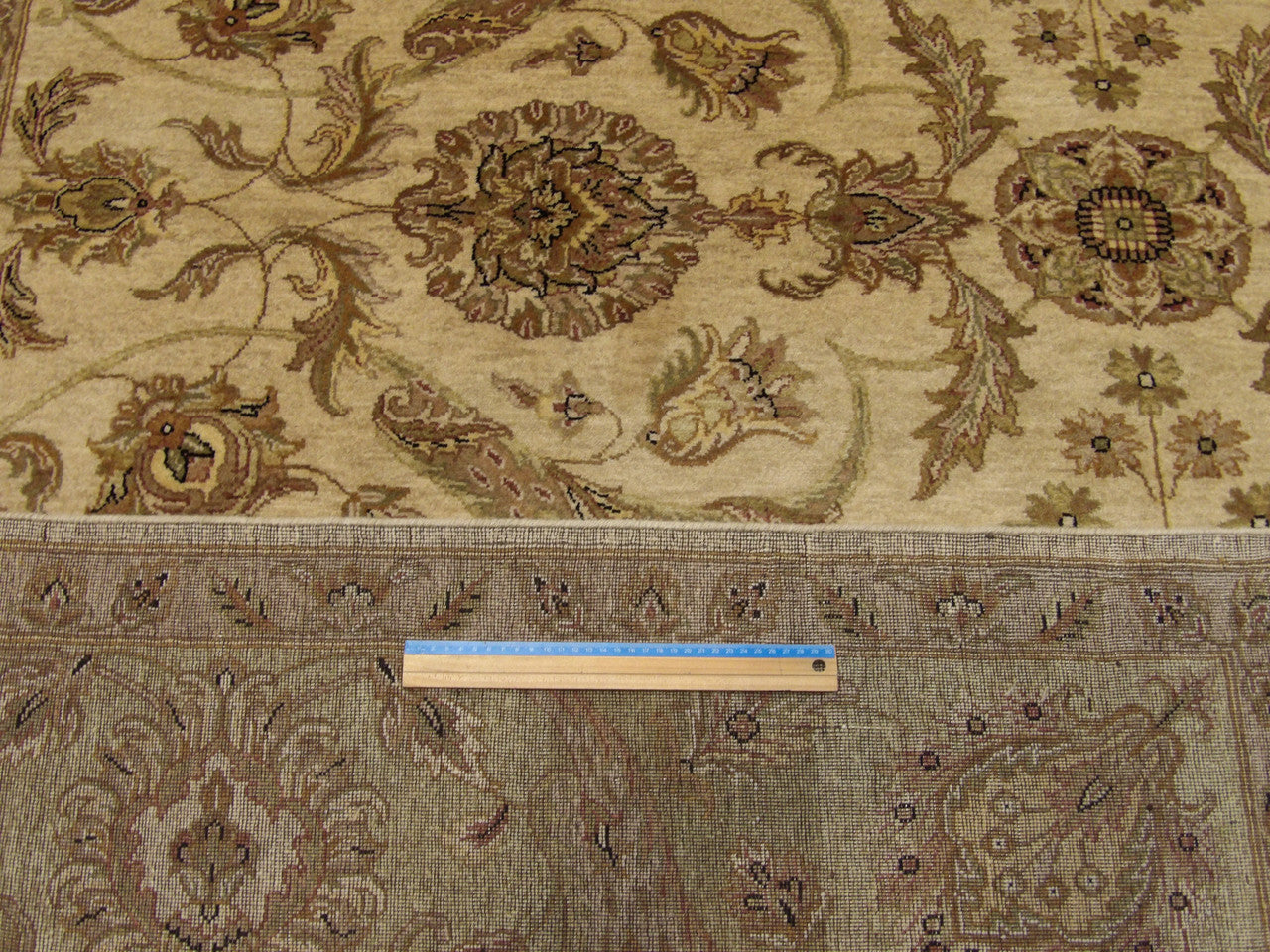 Green and ivory Kashan rug in room setting