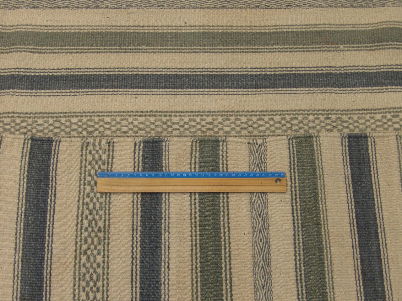 Blue and white coastal rug in room setting