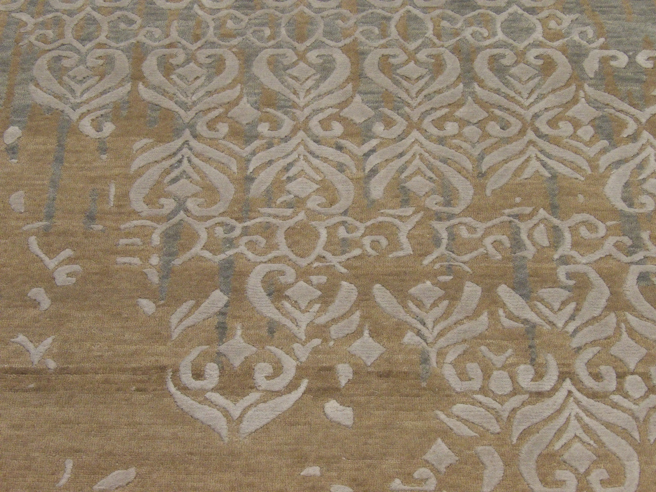 Modern rug edge and pile detail, gold and gray