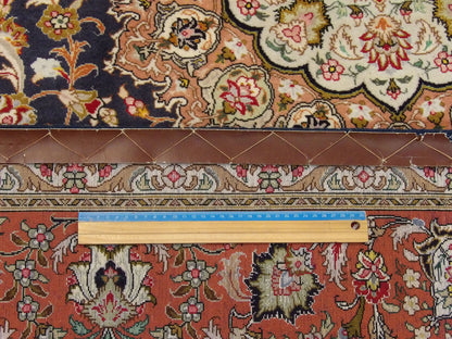 Blue and pink Qum rug in room setting