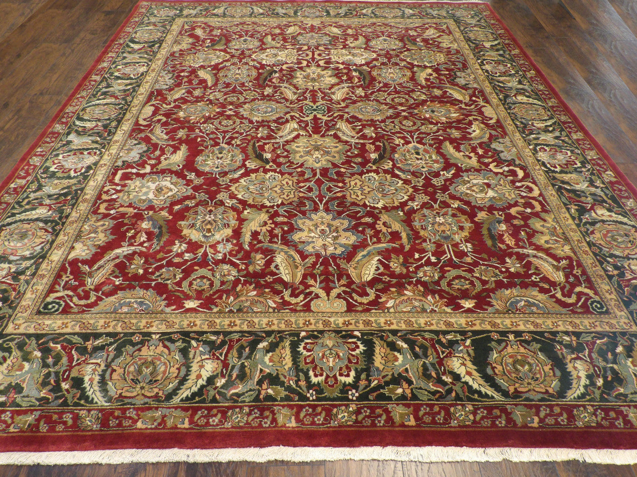 Close-up of wool pile, green and red rug