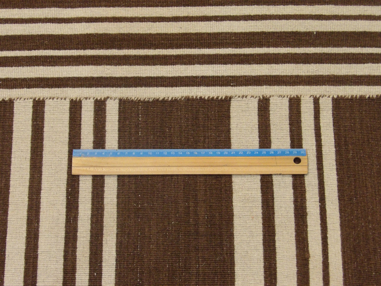 Coastal brown and ivory rug in room setting
