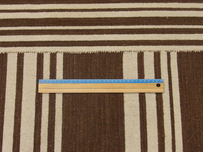 Coastal brown and ivory rug in room setting