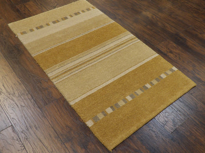 Full view of modern hand-knotted rug in gold