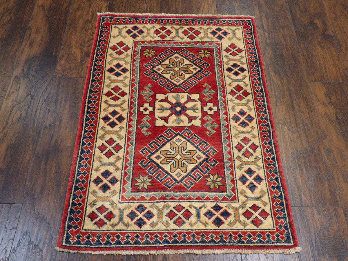 Close-up of wool pile, beige and red rug