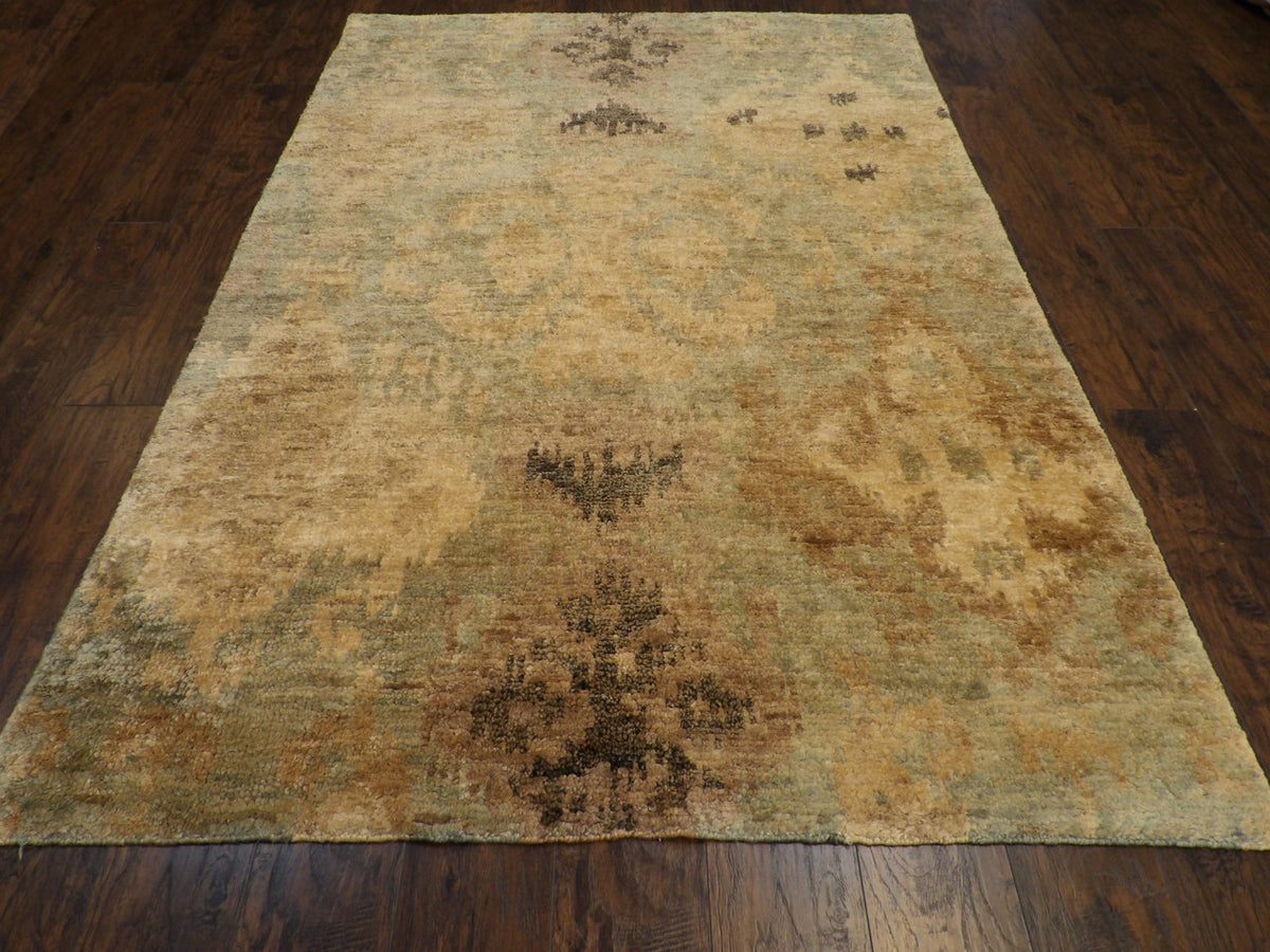 Close-up of wool-silk pile, gold and green rug