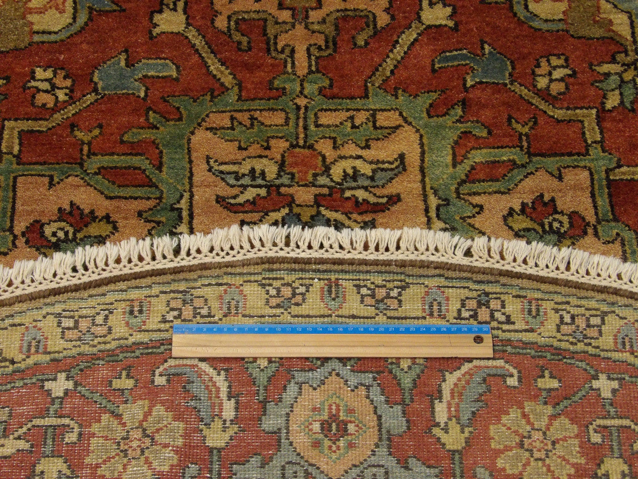 Full room view of round Tribal Sherapi hand-knotted rug