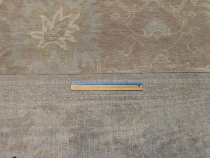 Brown and ivory Oushak rug in room setting