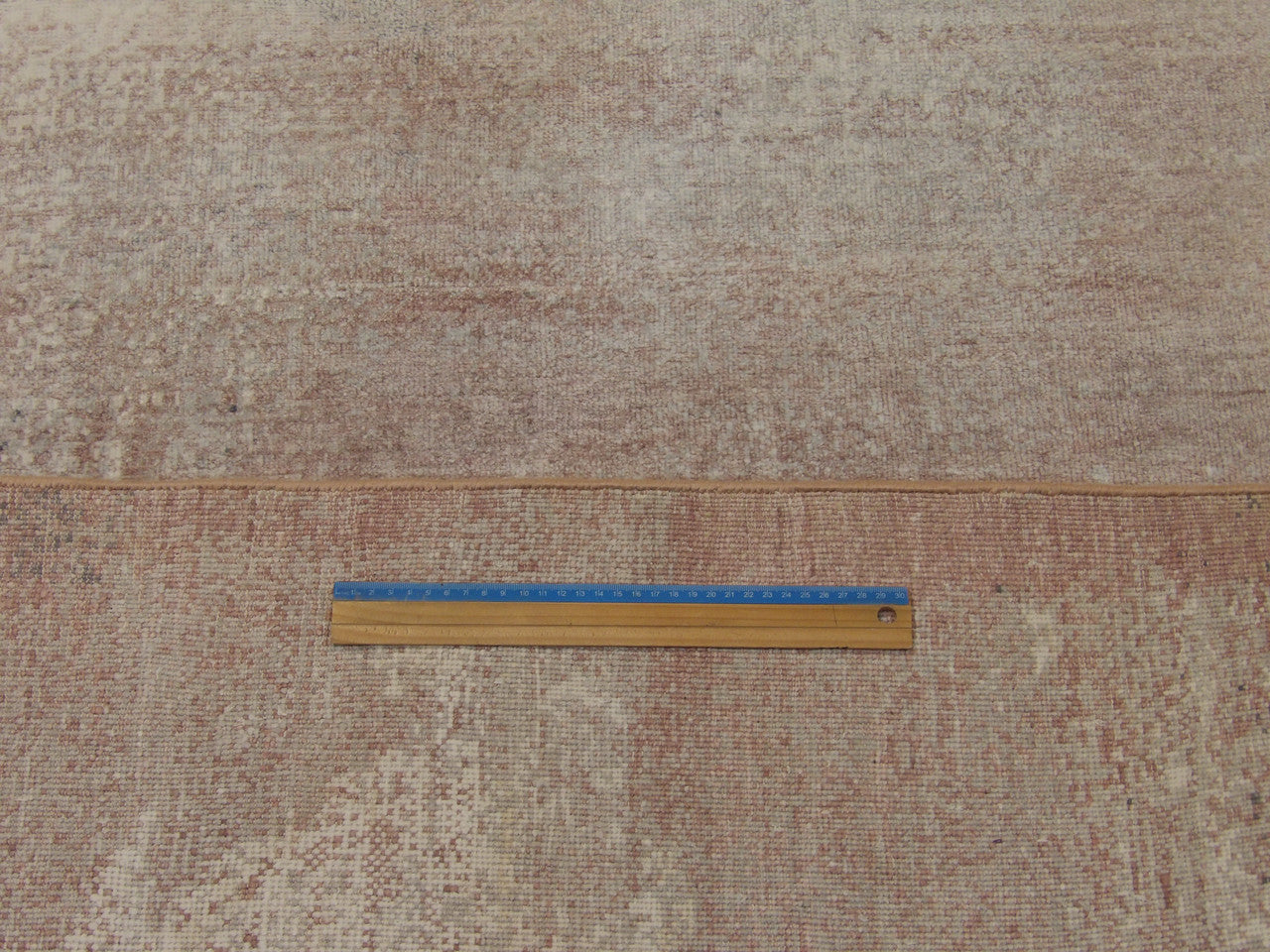 Gray and pink mosaic rug in room setting