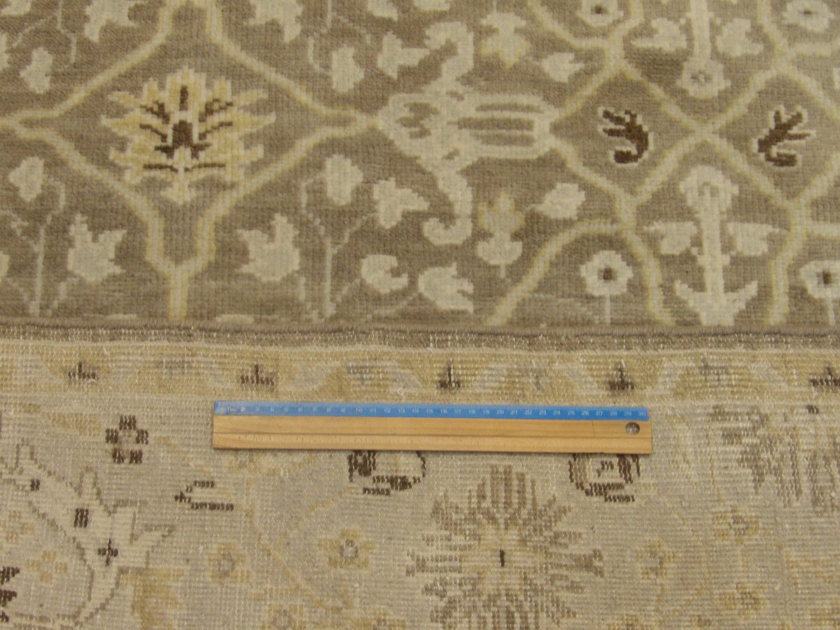 Brown and gold Oushak rug in room setting